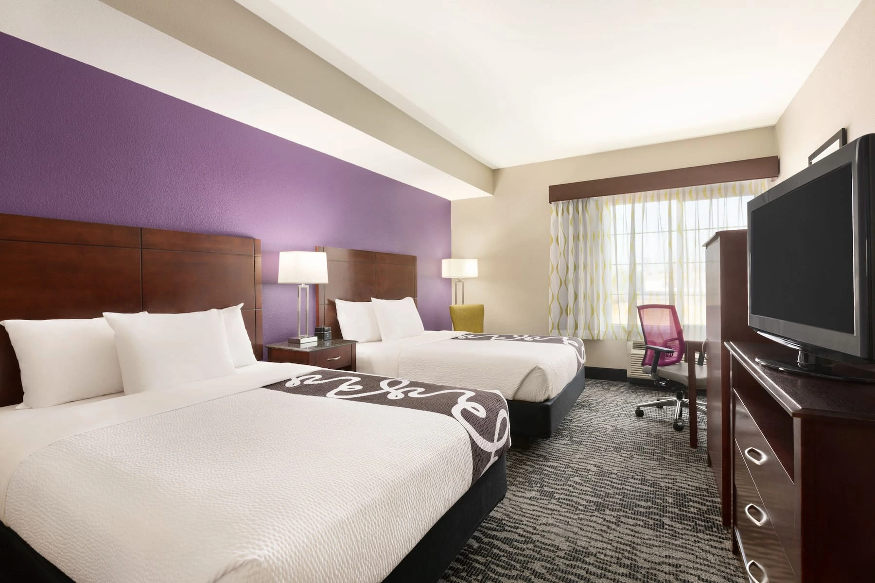 Guest room with television and practical furnishings